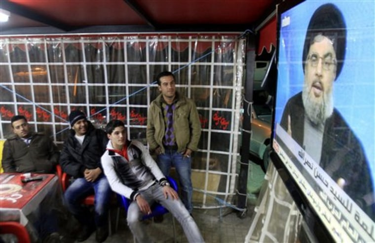 People watch the speech of Hezbollah leader Hassan Nasrallah on a screen at a cafe in the southern port city of Sidon, Lebanon, on Sunday. The leader of Lebanon's Shiite militant group Hezbollah says Saad Hariri should not return as prime minister. Nasrallah made his first public comments Sunday since ministers from his movement and their allies resigned from the Cabinet on Wednesday, toppling Hariri's Western-backed government.